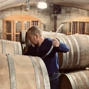 Keith Tyers, winemaker at Closson Chase, pulls wine from the barrel